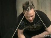 Blonde womens legs are spread wide by rope 8/16