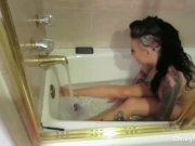 Busty starlet Christy Mack takes a bath