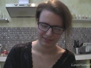 Solo girl with glasses chatting in the kitchen