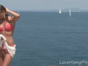 Gorgeous brunette removes her bikini on the beach 5/16