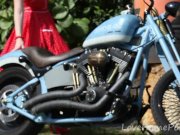 Cute blonde enjoys posing next to a bike 2/16