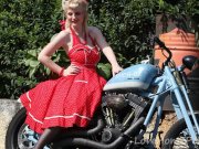 Cute blonde enjoys posing next to a bike 8/16