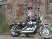 Cute teen is amazed by a big bike 1/16