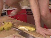 Hot and sexy redhead playing with a hard banana in the kitchen 7/16