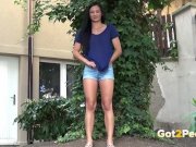 Public Pissing - Cute dark haired teen squats to pee in a garden 2/16