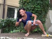 Public Pissing - Cute dark haired teen squats to pee in a garden 5/16
