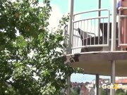 Redhead pees over her balcony in the city 13/16