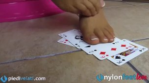 Blonde uses feet in pantyhose to play cards