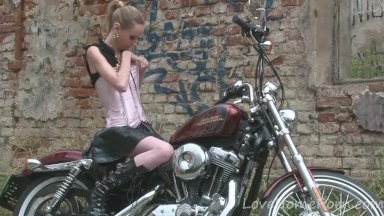 Cute teen is amazed by a big bike